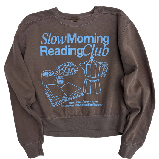 Brown sweatshirt with 'Slow Morning Reading Club' text and graphics